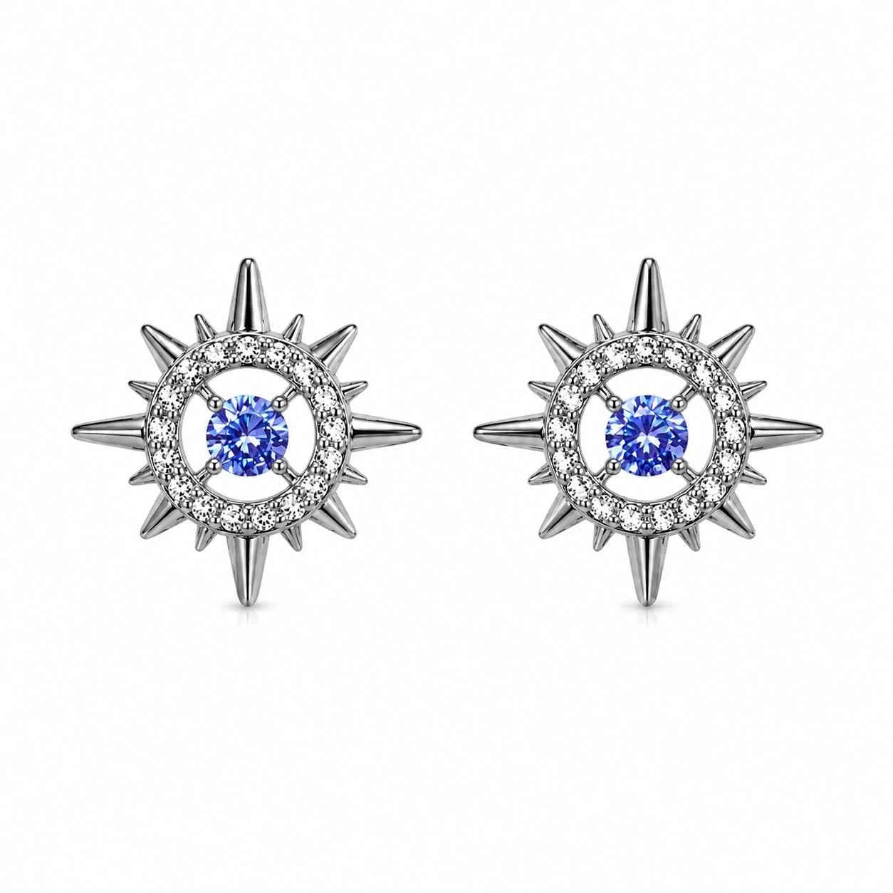 Pair of starburst stud earrings with blue center stones and silver-tone spiked halos