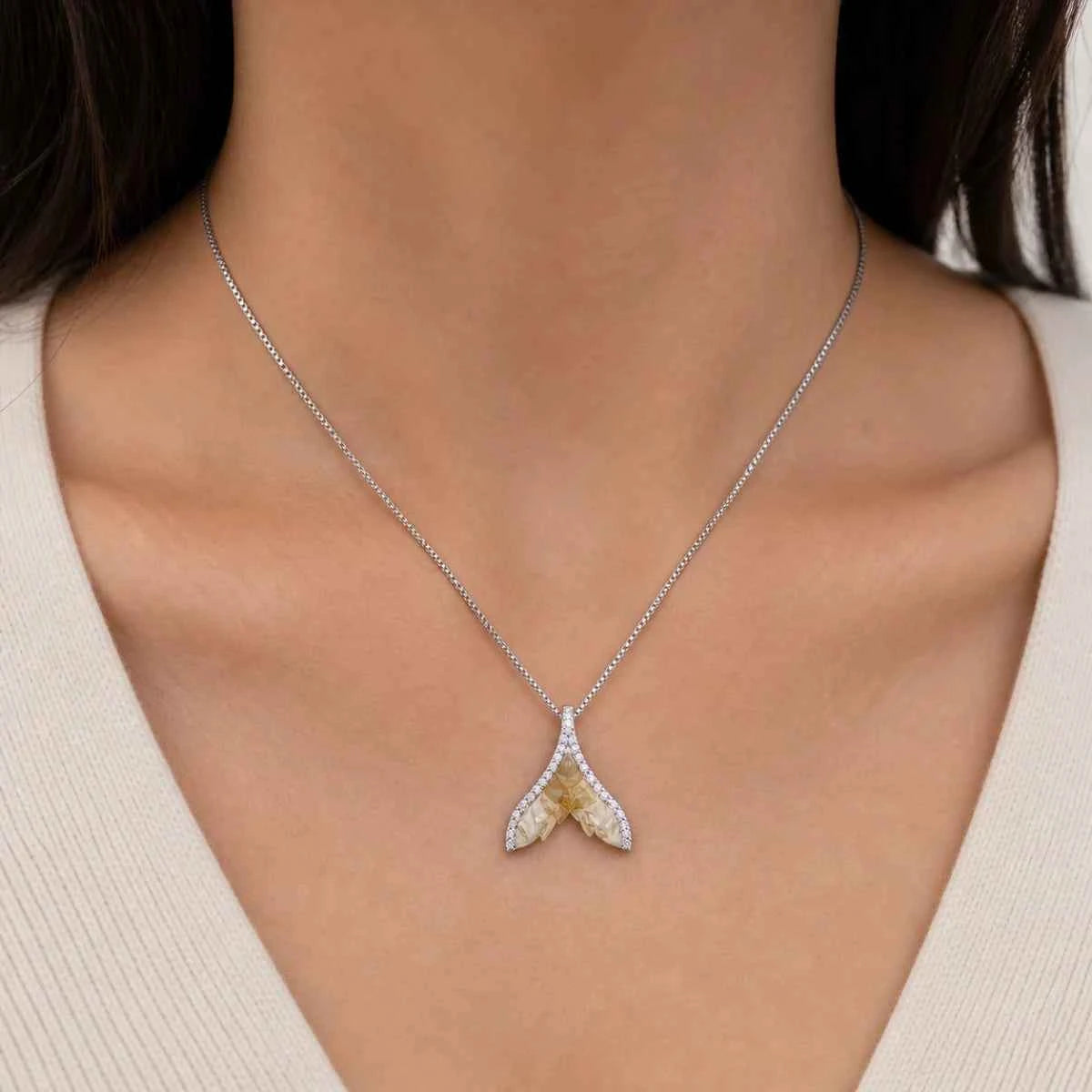 925 silver wing pendant necklace on a model, two arched wings with stones
