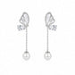 Butterfly-shaped earrings with pearl drops on a white background