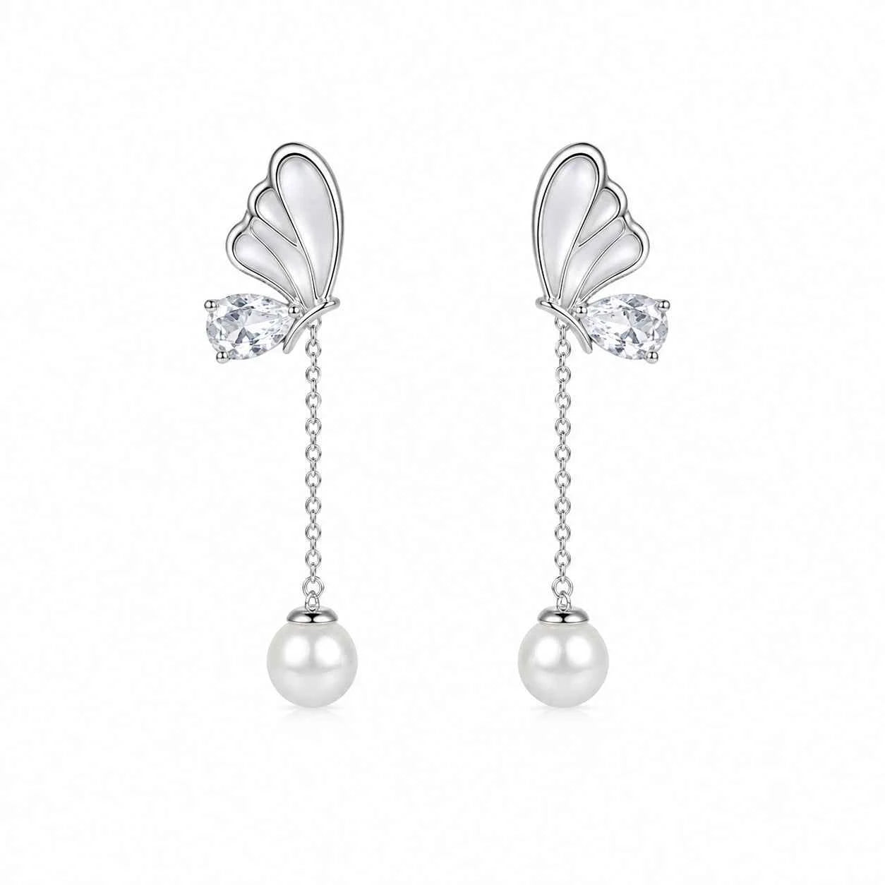 Butterfly-shaped earrings with pearl drops on a white background