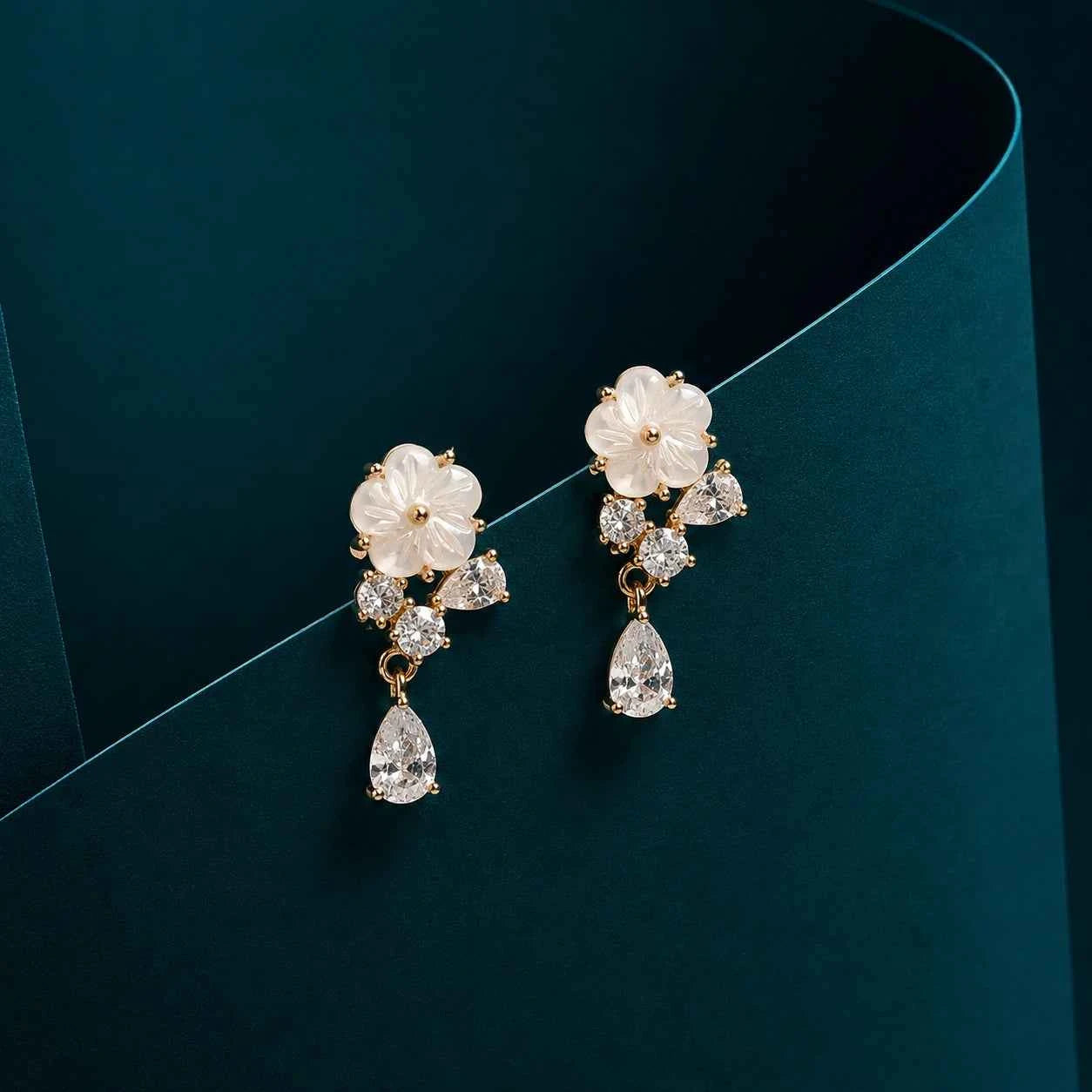Floral crystal drop earrings with pear-shaped crystal dangles and gold-tone accents