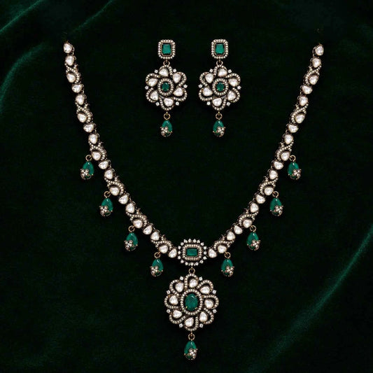 Emerald green floral pendant necklace set with matching drop earrings, silver-tone chain