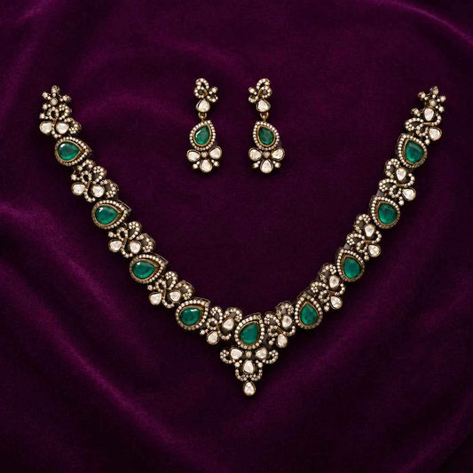 Gold-tone Victorian-style necklace set with green oval stones and floral drop earrings