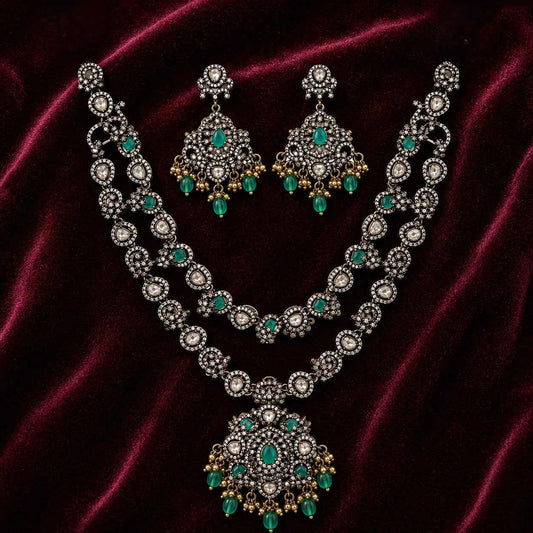 Emerald pendant necklace and matching earrings, oval stations with dangling teardrops