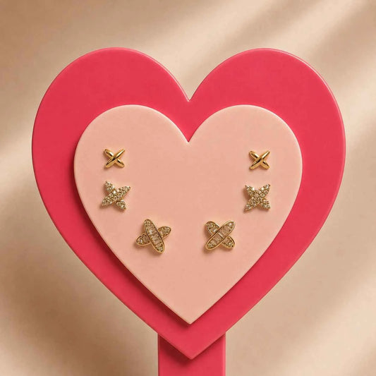 Gold-tone X-shaped side earrings with small dangling charms set