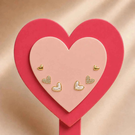 Heart earring set: multiple gold-tone and glitter hearts on red heart-shaped card
