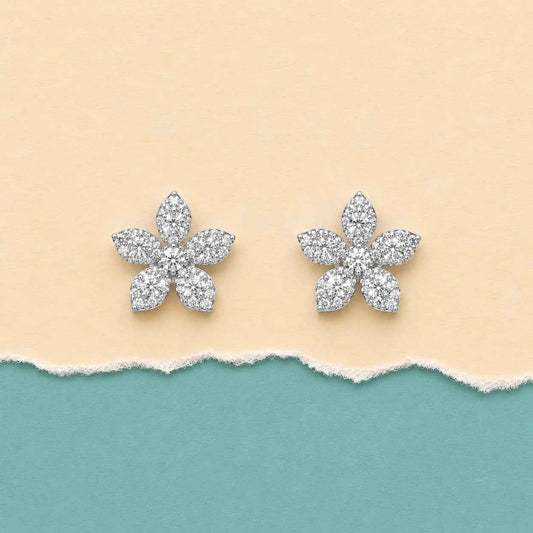 Flower-shaped stud earrings with sparkling clear stones, silver-tone petal design