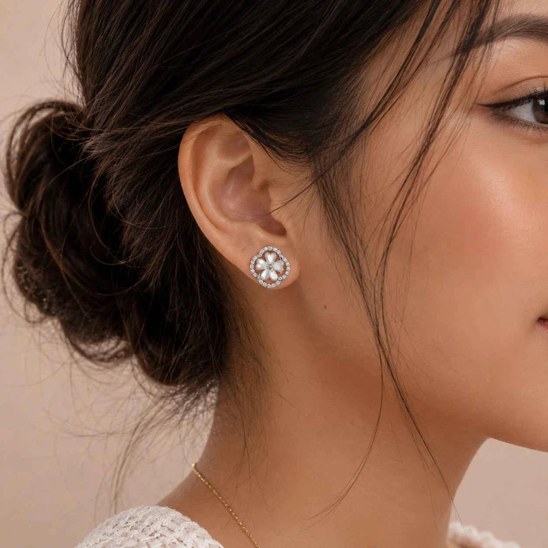 925 silver mother-of-pearl flower stud earrings with diamond halo, worn on ear