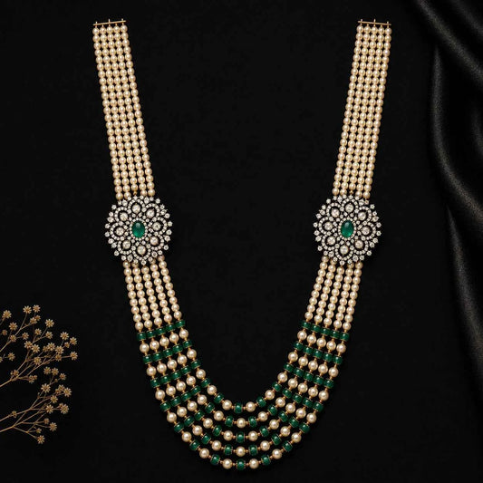 Layered pearl necklace with green gem medallion and cascading bead strands