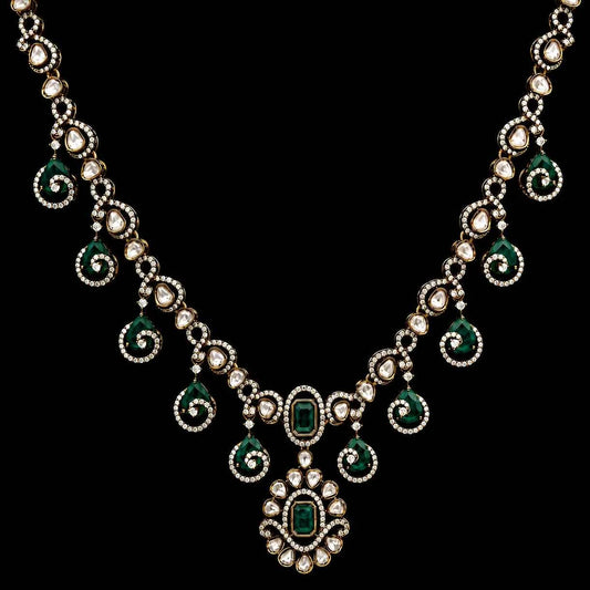 Gold-tone emerald green necklace with teardrop drops and center oval pendant