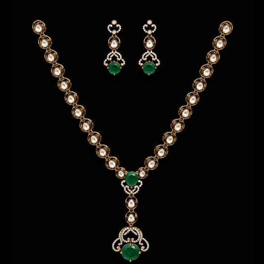 Gold-tone necklace and drop earrings with green oval stones and central heart pendant