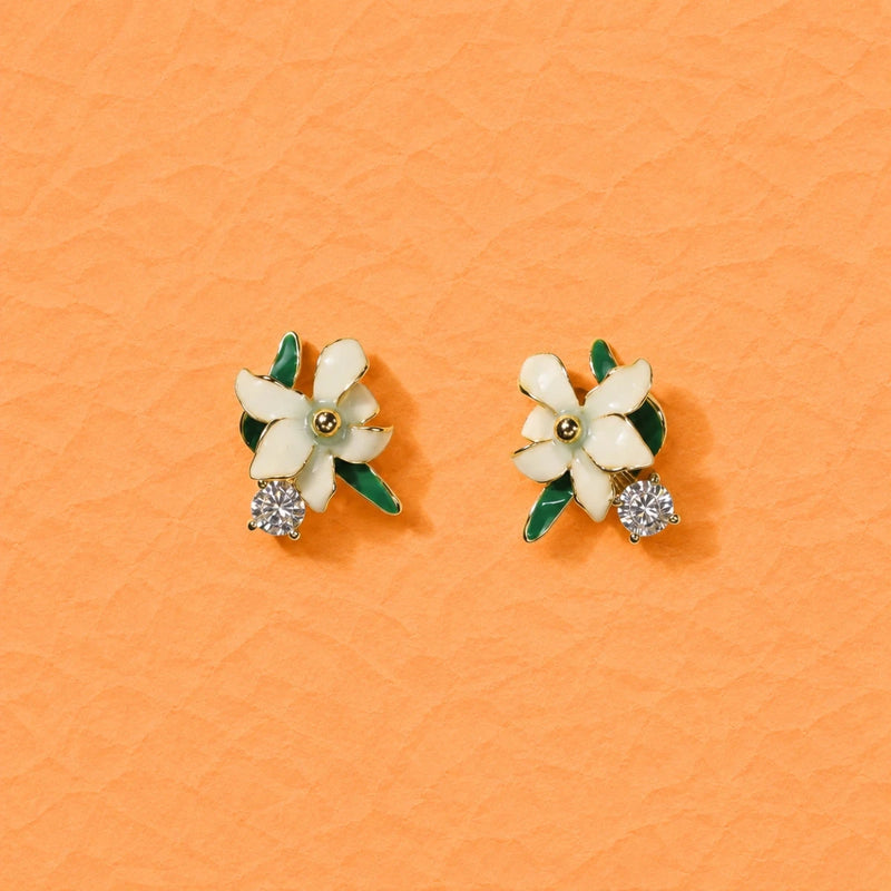 Silver flower stud earrings with green enamel petals and clear crystal accents