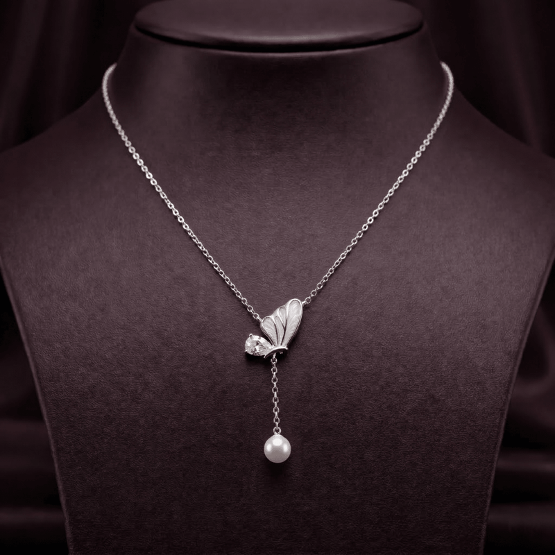 Silver butterfly pendant necklace with dangling pearl drop and small crystal accents