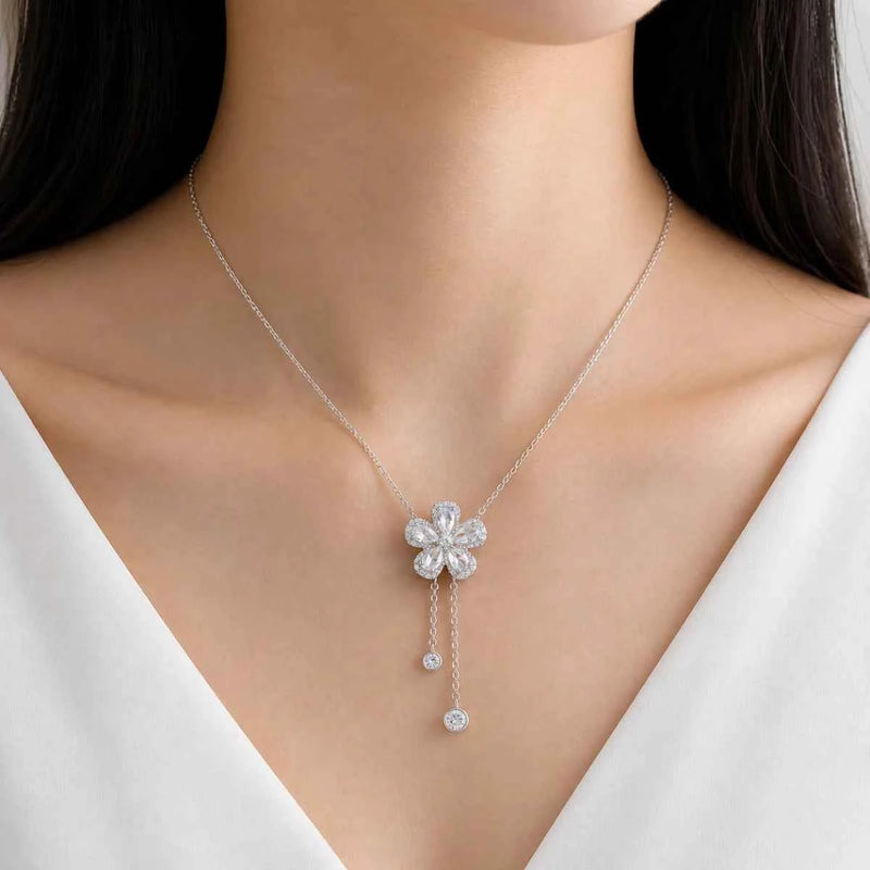 Silver 925 drop bloom necklace on model with flower pendant and dangling charm drops