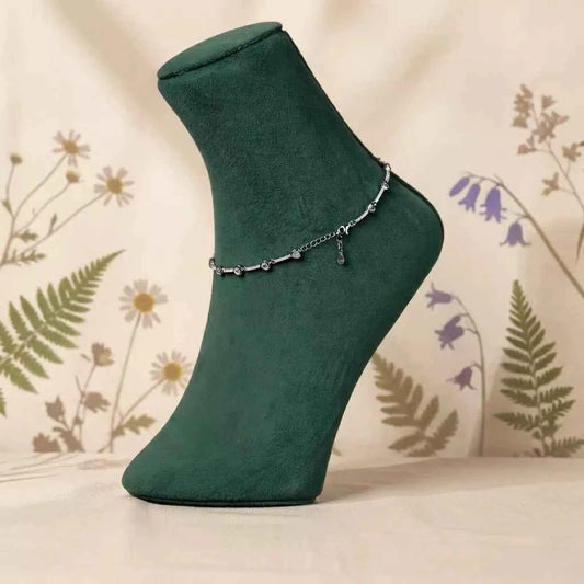 Silver beaded anklet bracelet on green sock with small drop charm