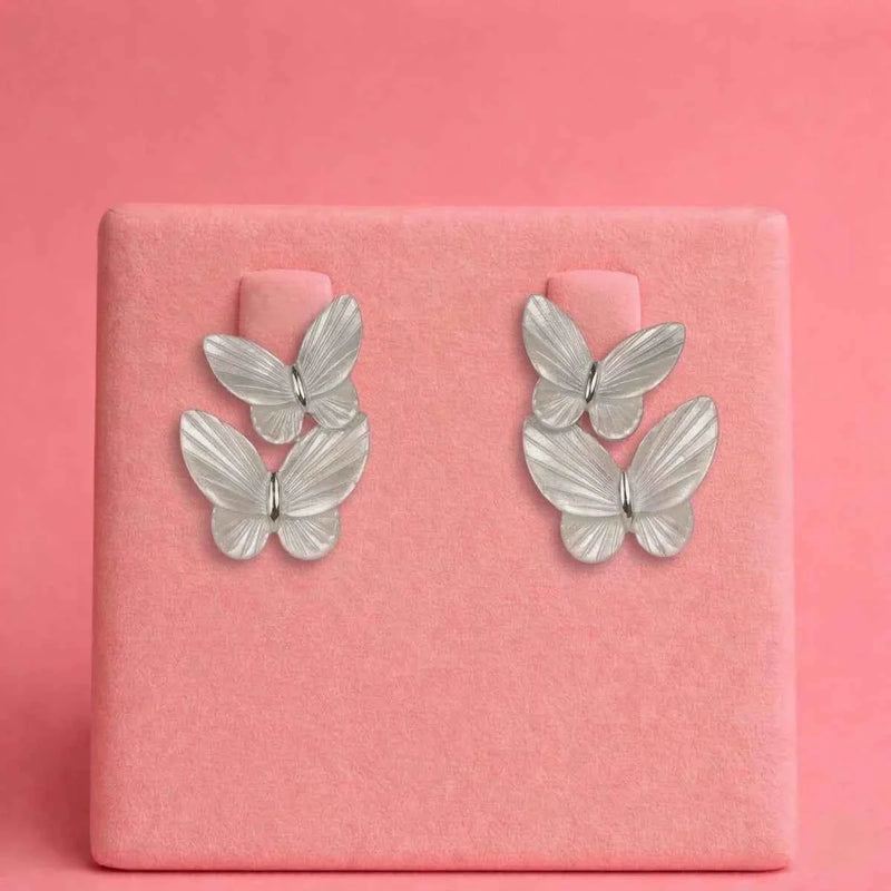 Silver butterfly stud earrings with four layered wings in a duo cluster.