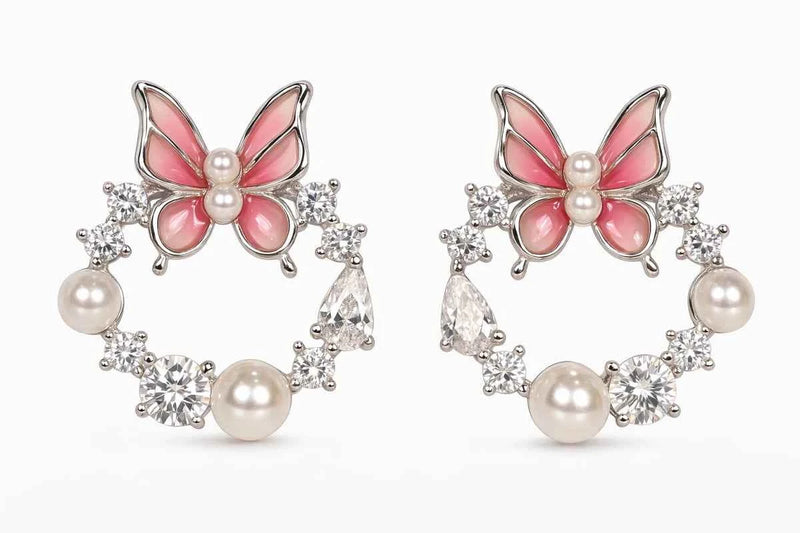 Pair of butterfly hoop earrings with pink enamel, pearl drops, and zircon ring details
