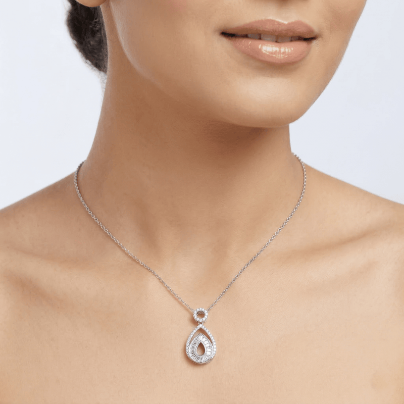 Teardrop halo diamond pendant necklace in 925 silver worn at neckline on model