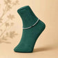 Silver 925 anklet pair with sparkling tennis-style chain on green sock