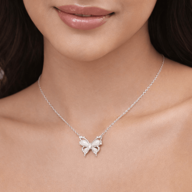 Silver butterfly pendant necklace close-up with zirconia center and wing details