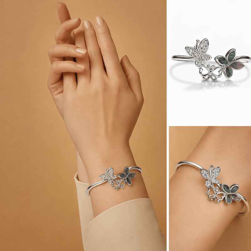 925 silver cuff bracelet with butterfly and clover charms, green enamel accents on hand