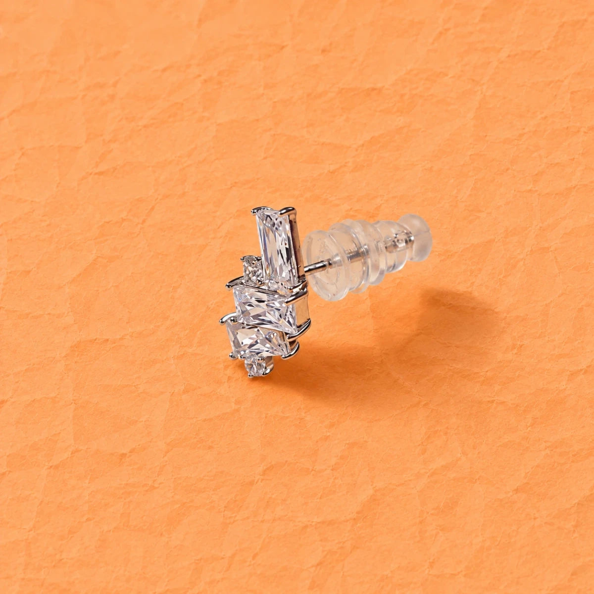 Geometric triple zirconia stud earrings in 925 silver, front view with clear baguettes