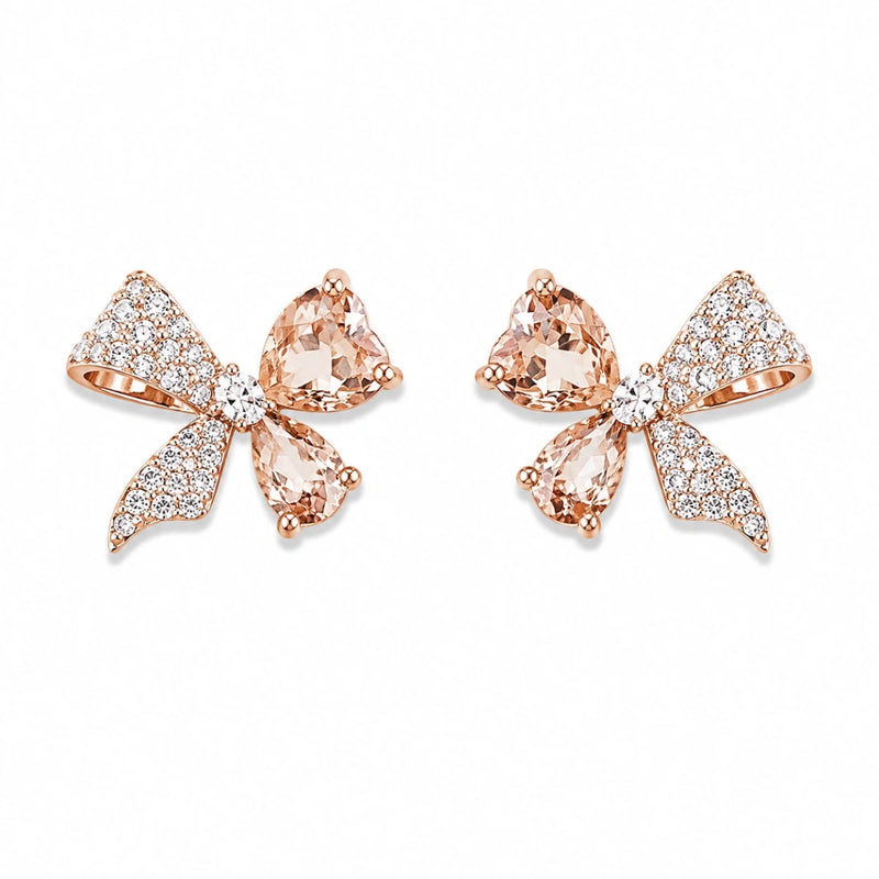Bow-shaped crystal stud earrings in rose-gold tone with clear stones and marquise drops