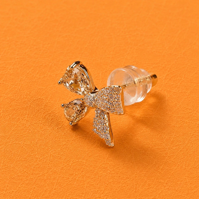 Rose-gold tone bow crystal stud earring with clear stones and a teardrop center