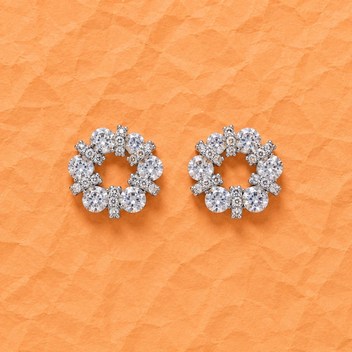 Silver halo circle bar stud earrings featuring round prong-set crystal stones.