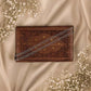 925 silver chain bracelet with dangling charm on a rectangular wooden display tray