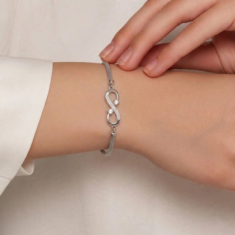 Rhinestone silver infinity bracelet on wrist with textured chain