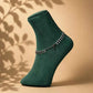 925 silver anklets with cascading leaf-like charms across ankle on dark green sock