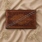 925 silver chain anklet with bead-like links, laid across a wooden box