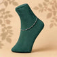 925 silver chain anklet with bead-like links on a green socked foot
