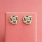 Mint green swirl pinwheel stud earrings in silver-tone with clear stone details