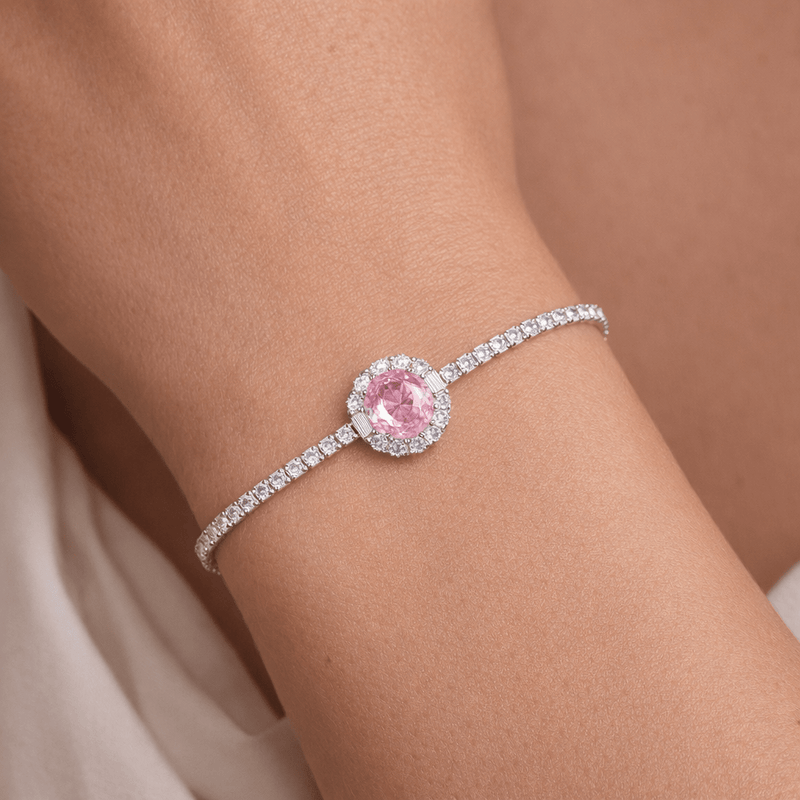 Silver tennis bracelet with oval pink gemstone halo and pavé detail, adjustable clasp
