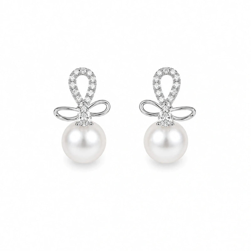 Pair of silver bow drop stud earrings with zirconia accents and white pearls