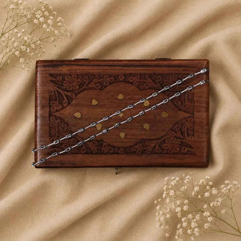 Silver 925 anklet chain on wooden tray, with small rectangular link segments
