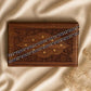 Silver beaded bracelet on patterned wooden display box