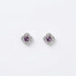 Purple crystal clover stud earrings in silver-tone, shown as a matching pair