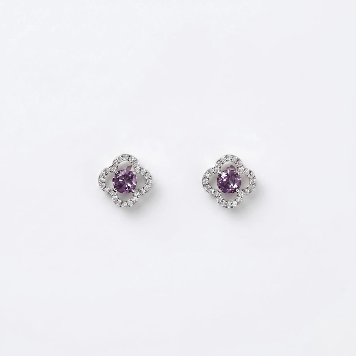 Purple crystal clover stud earrings in silver-tone, shown as a matching pair