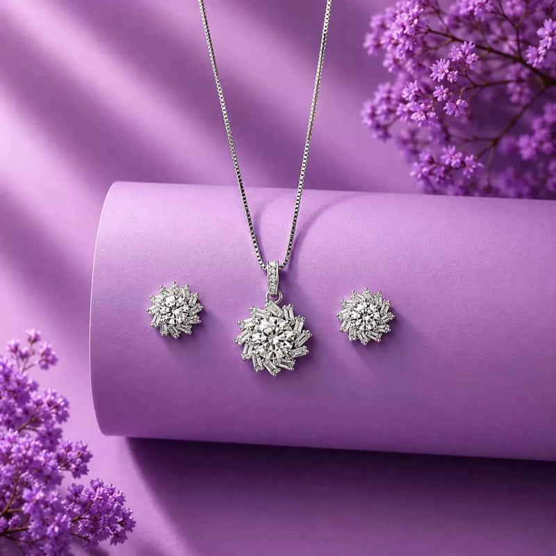 Silver radiant bloom pendant with matching stud earrings, snowflake-style flower design.