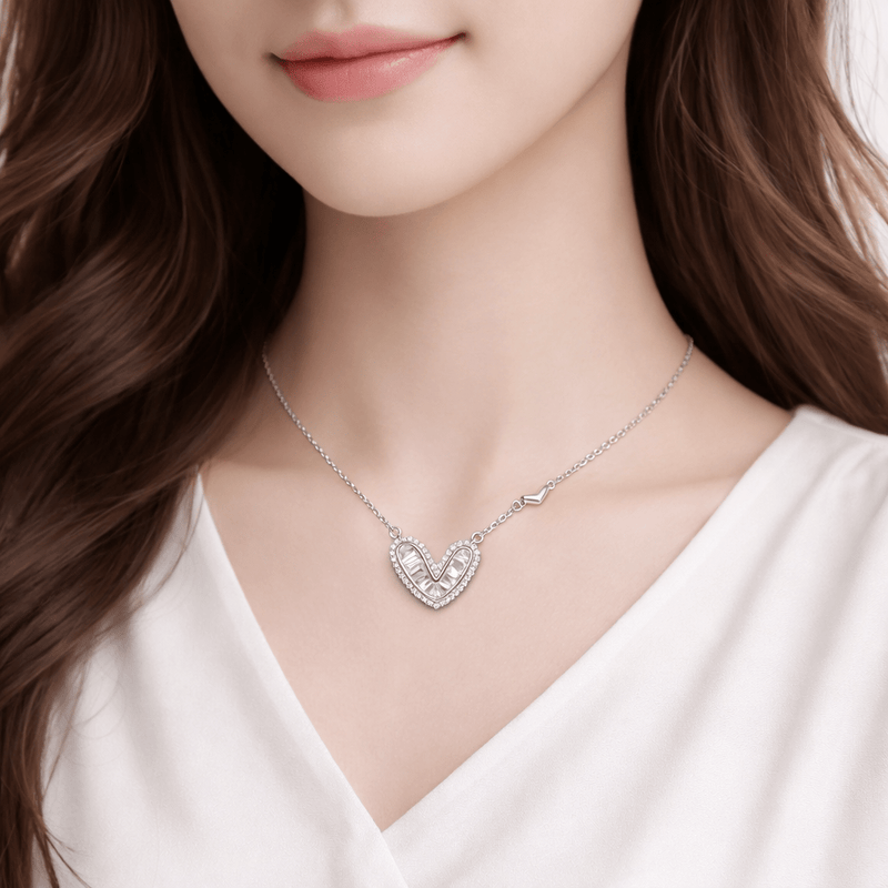 Silver heart pendant necklace on neckline, radiant halo with chevron accents
