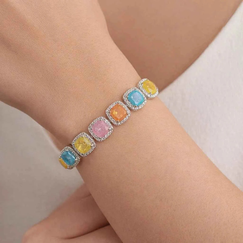 Multicolor square halo bracelet on wrist with silver links and toggle clasp