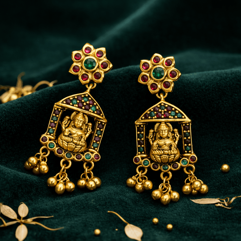Gold-tone temple earrings with ruby and green stones, framed deity panel and three bells