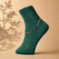 Green ankle sock with silver chain anklet featuring small dangling drops at the side